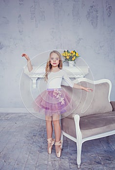 Little child girl dreams of becoming ballerina