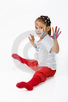 Little child girl with hands painted in colorful paint