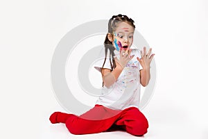 Little child girl with hands painted in colorful paint