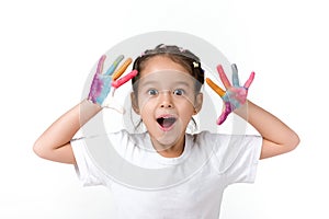 Little child girl with hands painted in colorful paint