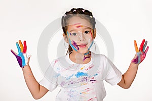 Little child girl with hands painted in colorful paint