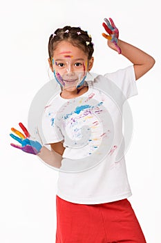 Little child girl with hands painted in colorful paint