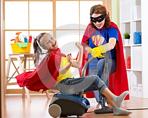 Little child girl and her mother play while doing cleanup at home