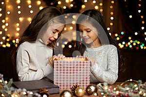 Little child girl opening magic Christmas gift box