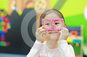 Little child girl playing Magnets toy for brain development