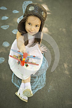 Little child girl plays astronaut