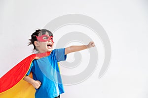 Little child girl plays superhero. Child on the white background. Girl power concept