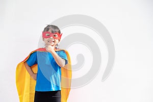 Little child girl plays superhero. Child on the white background. Girl power concept