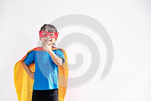 Little child girl plays superhero. Child on the white background. Girl power concept