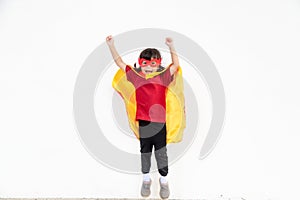 Little child girl plays superhero. Child on the white background. Girl power concept