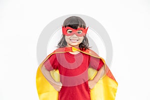 Little child girl plays superhero. Child on the white background. Girl power concept