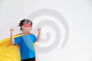 Little child girl plays superhero. Child on the white background. Girl power concept