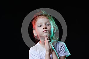 little child girl praying with hands held together