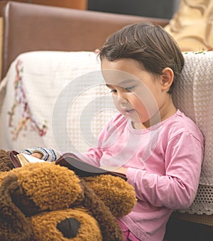 Little child girl reading the Bible