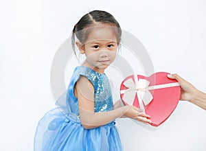 Little child girl receiving red heart gift box isolated on white background. Concept Valentine`s Day