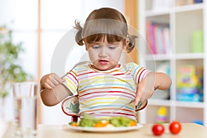 Little child girl refusing to eat her dinner