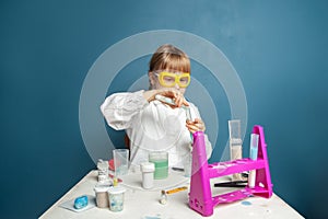 Little child girl student making science experiment in lab