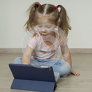 Little child girl using tablet pc