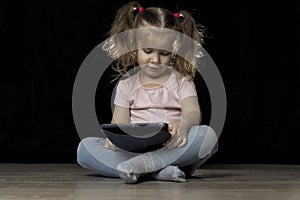 Little child girl using tablet pc