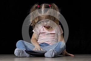 Little child girl using tablet pc