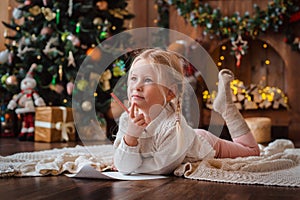 Little child girl writes letter Santa Claus and dreams of a gift background