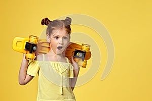 little child girl with yellow skateboard