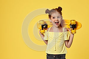 little child girl with yellow skateboard