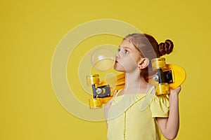 little child girl with yellow skateboard