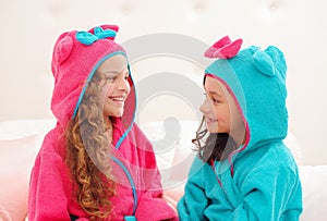 Little child having playing and looking each other while wearing bath towel on their head