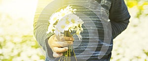 Little Child Is Holding A Bouquet Of Daisy Flower