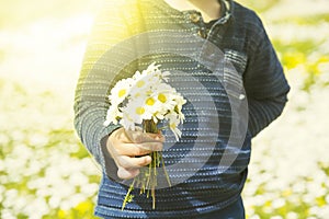 Little Child Is Holding A Bouquet Of Daisy Flower