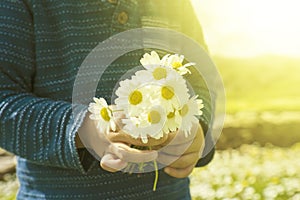 Little Child Is Holding A Bouquet Of Daisy Flower