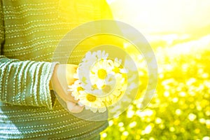 Little Child Is Holding A Bouquet Of Daisy Flower