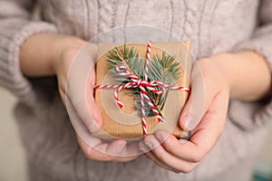 Little child holding decorated box, closeup. Christmas gift
