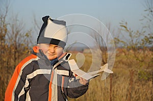 Little child holding plane model