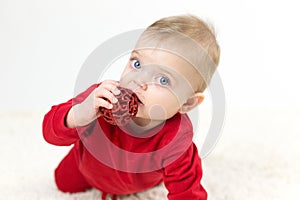 Little child holding a toy in his mouth