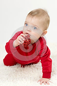 Little child holding a toy in his mouth