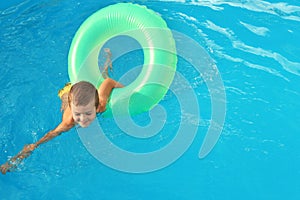 Little child with inflatable ring in swimming pool. Dangerous situation