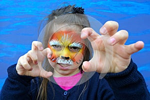 Little child with lion face painting