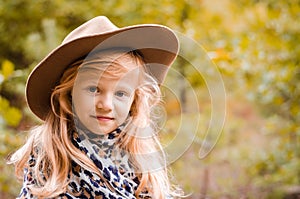 Little child  with long blond hair and hat