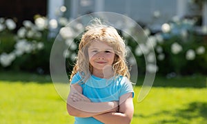 Little child play on summer backyard. Lifestyle portrait of cute kid outdoors. Summer kids outdoor portrait. Close-up