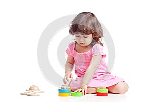 Little child playing with colorful toys