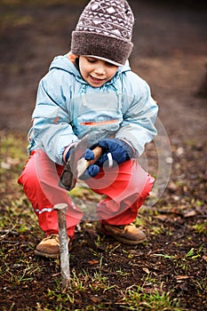 Little child playing with dangerous tools