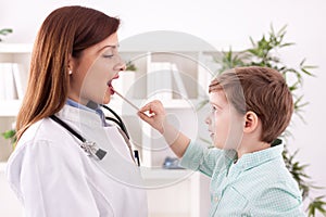 Little child playing with doctor examining