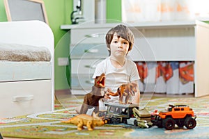 Little child playing with lots of colorful plastic toys at home. educational games at home or in kindergarten