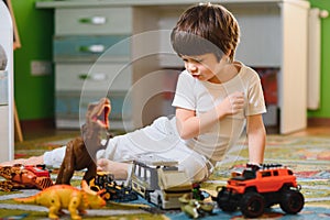 Little child playing with lots of colorful plastic toys at home. educational games at home or in kindergarten