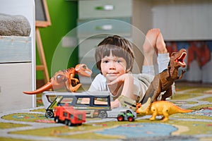 Little child playing with lots of colorful plastic toys at home. educational games at home or in kindergarten.