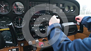 Little child playing pilot in the cabin of light sport aircraft, childhood dreams of flying, closeup of instrument panel