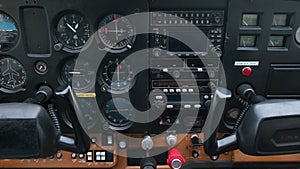 Little child playing pilot in the cabin of light sport aircraft, childhood dreams of flying, closeup of instrument panel