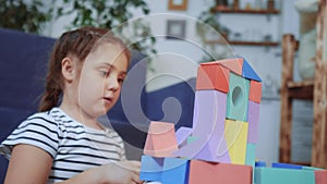 little child plays lockdown with blocks in the kindergarten. kid dream a preschool education concept. kid girl playing